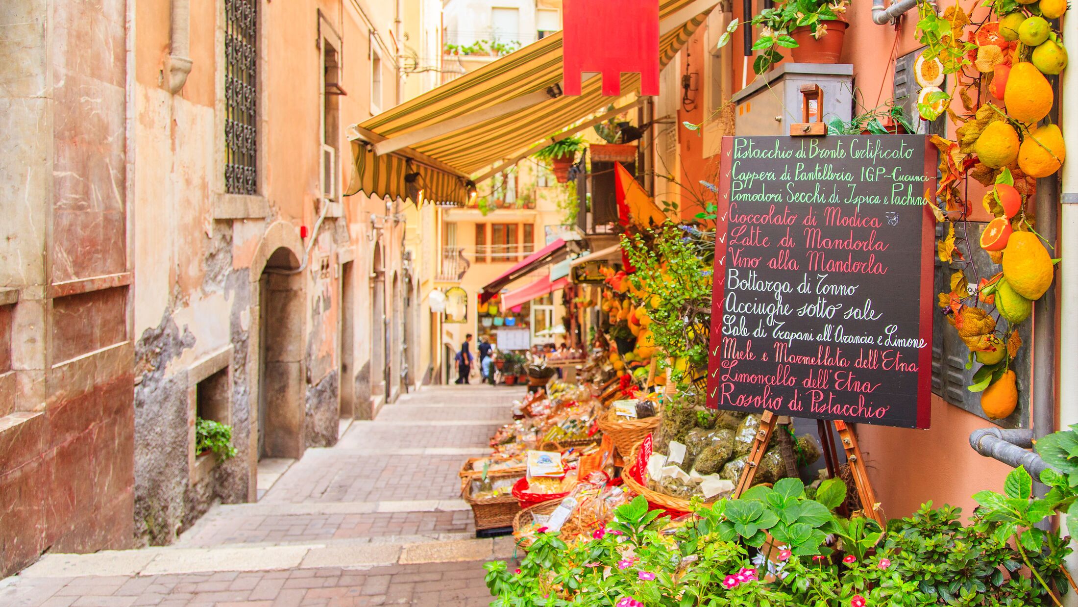 Entrance to local shop in Taormina, Sicily. Writing on the black table lists itmes on promotion.