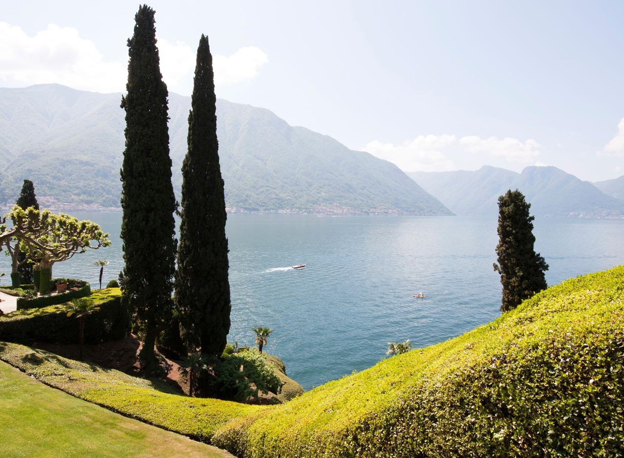 a large body of water with a mountain in the background