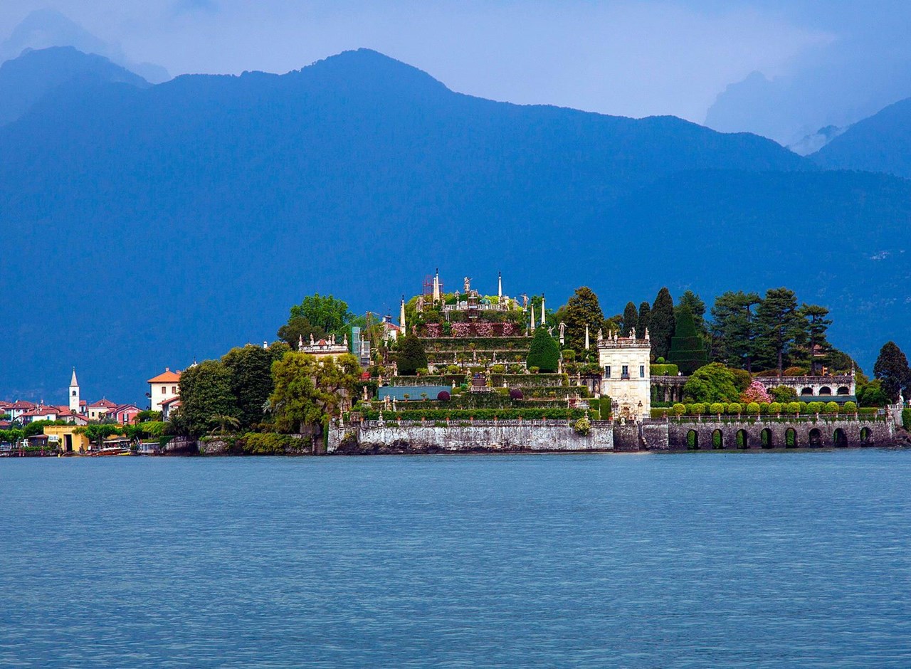 a large body of water with a mountain in the background