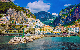Wonderful Italy. The small haven of Amalfi village with a turquoise sea and colorful houses on the slopes of the coast