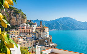 Small city Atrani on Amalfi Coast in province of Salerno, Campania region, Italy. Amalfi coast on Gulf of Salerno is popular travel and holyday destination in Italy. Ripe yellow lemons in foreground.