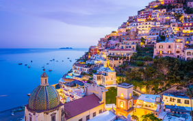 Positano, Amalfi Coast, Campania, Sorrento, Italy. View of the town and the seaside in a summer sunset