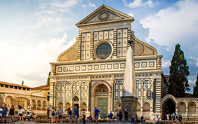 Santa Maria Novella in pink flowers in a summer day. Florence, Italy