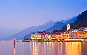 Tranquil sunset and evening illuminations of the beautiful town of Bellagio on Lake Como in Italy.