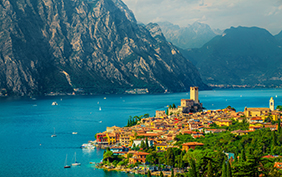 Fantastic summer vacation place, beautiful Malcesine mediterranean cityscape with colorful buildings view from the hill, lake Garda, Italy, Europe