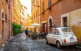 Rome, Italy - May 28, 2017: Cozy street in Trastevere with vintage car parked.