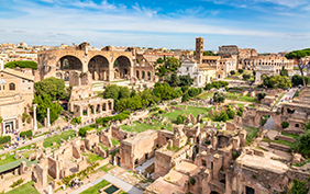 Aerial panoramic cityscape view of the Roman Forum and Roman Colosseum in Rome, Italy. World famous landmarks in Italy during summer sunny day.