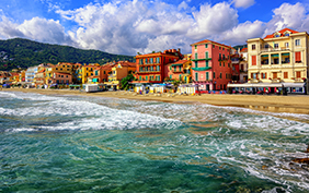 Mediterranean sand beach in traditional touristic town Alassio on italian Riviera by San Remo, Liguria, Italy