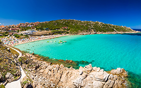 Spiaggia di Rena Bianca beach with red rocks and azure clear water, Santa Terasa Gallura, Costa Smeralda, Sardinia, Italy.