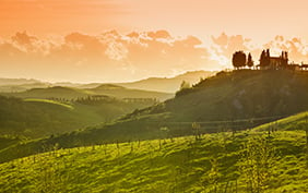 Tuscan Landscape near the city of Montaione at sunset. A farm on the hill.