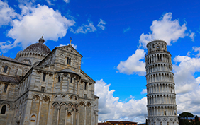 View of Cloudy blue sky in Pisa Cathedral (Duomo di Pisa) with Leaning Tower  (Torre di Pisa) Tuscany, Italy.The Leaning Tower of Pisa is one of the main landmark in Italy.