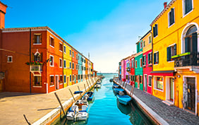 Burano island canal, colorful houses and boats, Venice Italy Europe