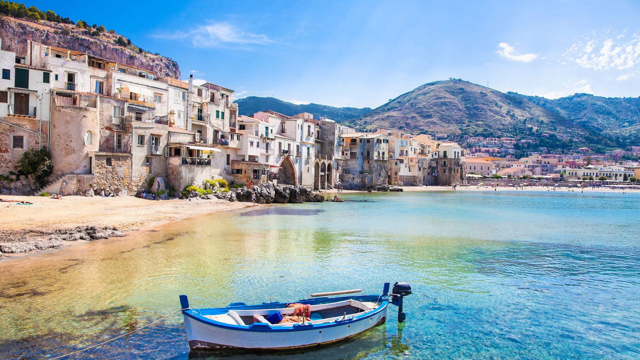 Beautiful old harbor with wooden fishing boat in Cefalu, Sicily, Italy.