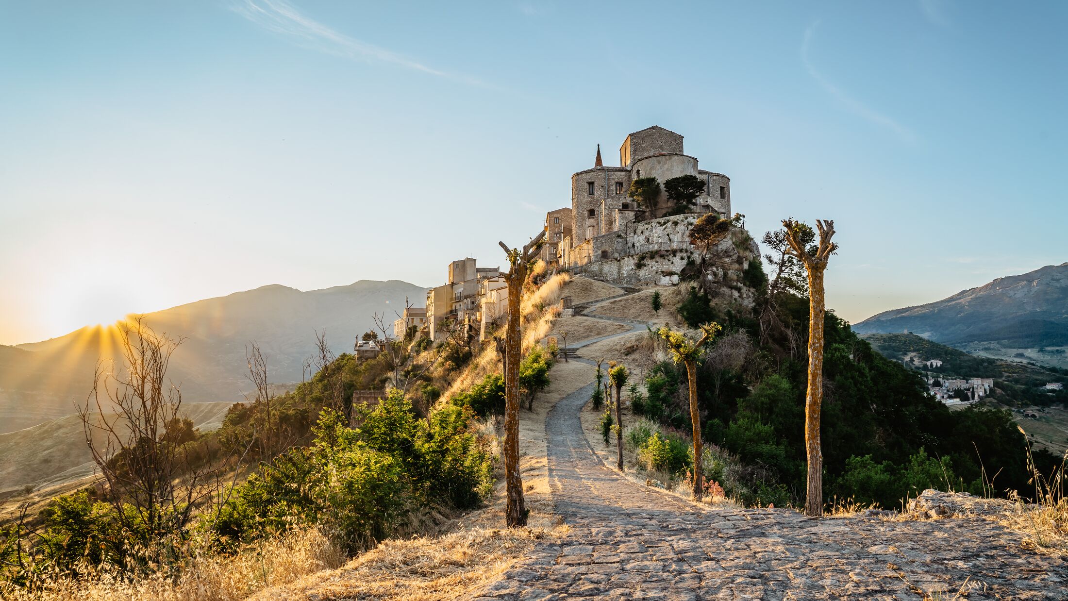 Stone village of Petralia Soprana,the highest village in Madonie mountain range,Sicily,Italy.Church of Santa Maria di Loreto at sunset.Picturesque stone houses,narrow cobbled streets,views of town