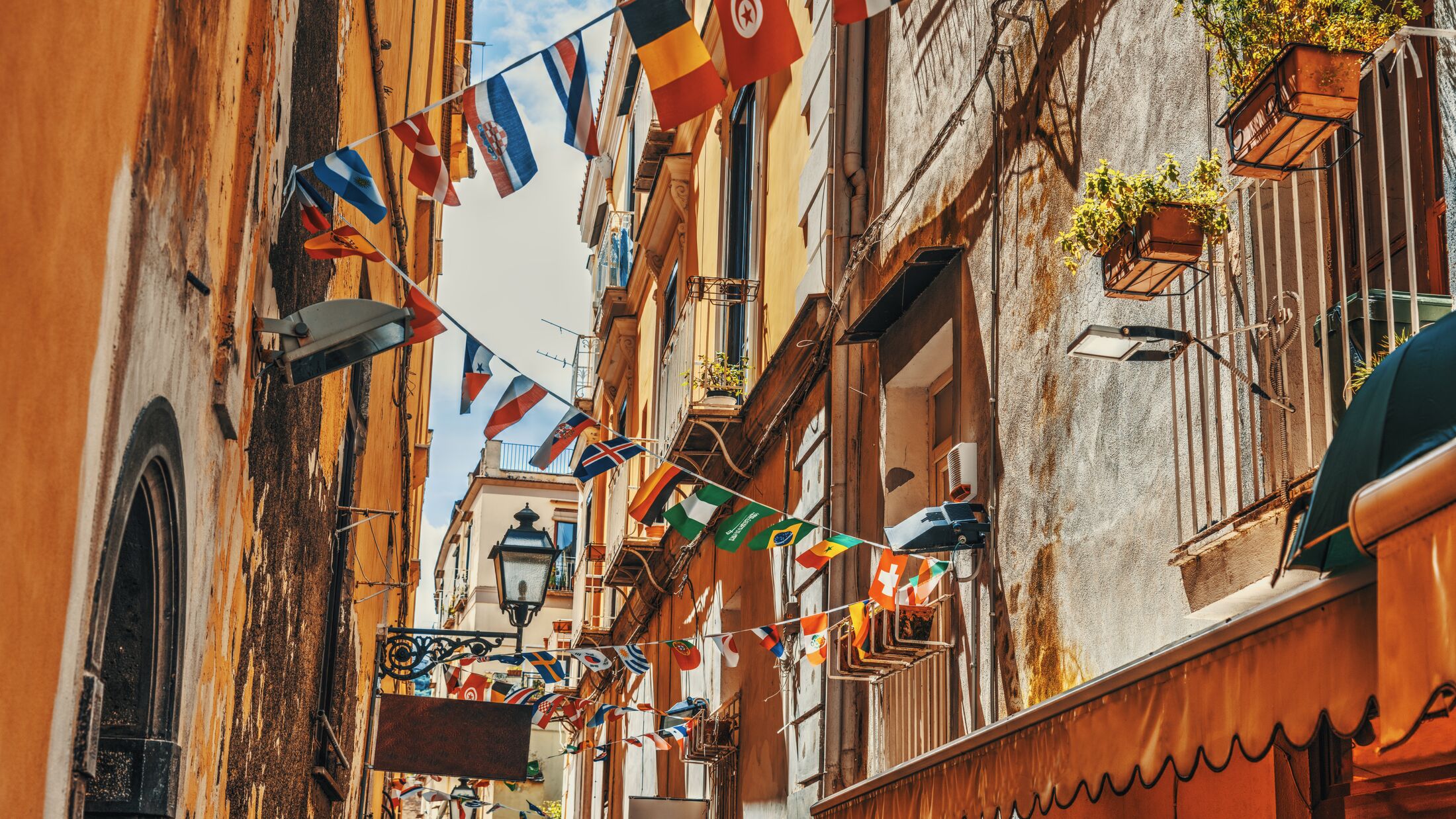 Flags on a narrow alley in old town Sorrento, Italy