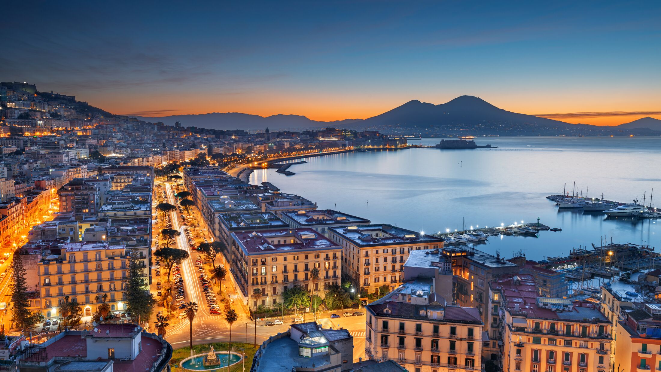 Naples, Italy aerial skyline on the bay with Mt. Vesuvius at dawn.