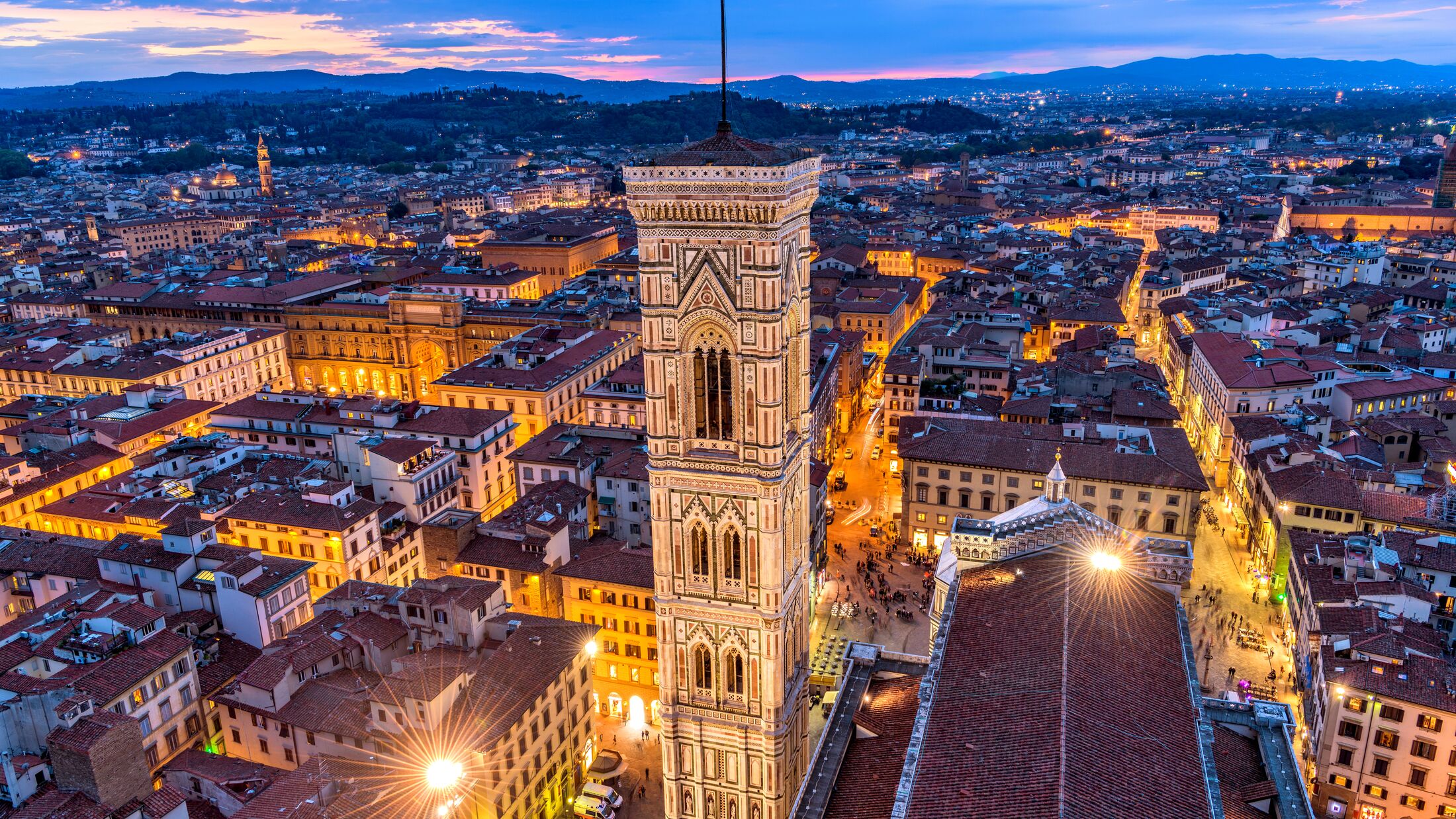 Giotto's Campanile - An aerial dusk view of Giotto's Campanile and the historical Old Town of Florence, as seen from the top of Brunelleschi's Dome of the Florence Cathedral. Florence, Tuscany, Italy.