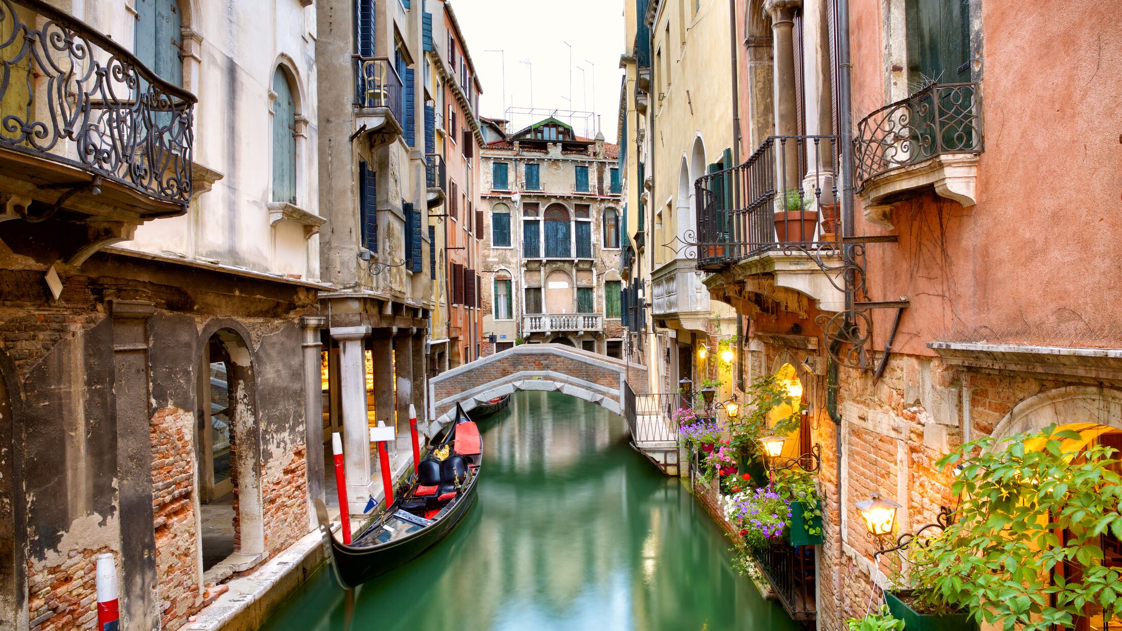 Traditional canal street with gondola in Venice, Italy