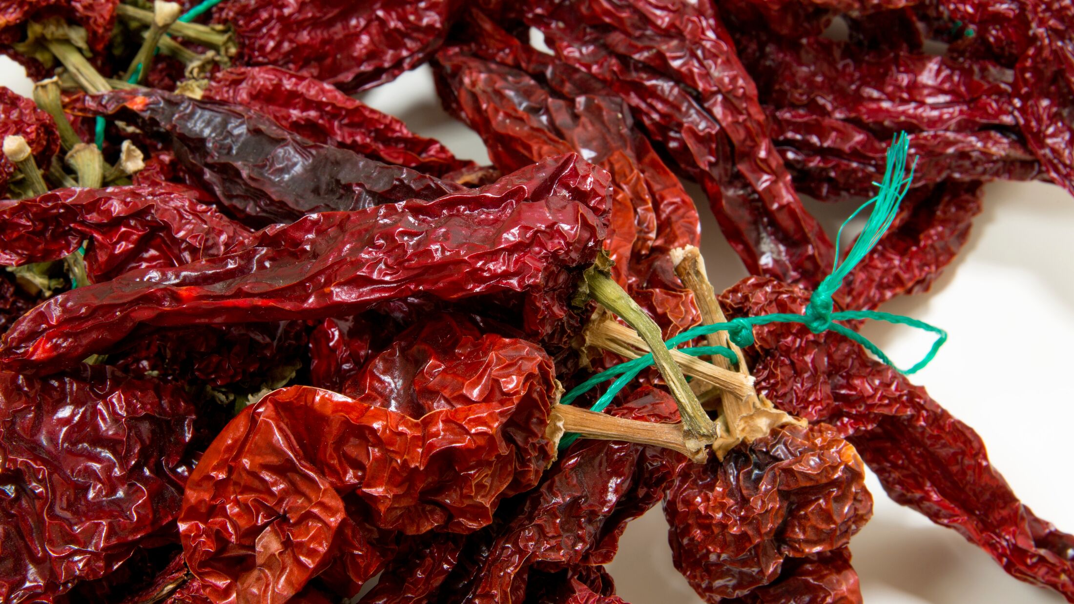 Closeup of peperoni cruschi, an air-dried crunchy sweet pepper used in the cuisine of Basilicata in Italy. Typical product of Lucan cuisine on white background.