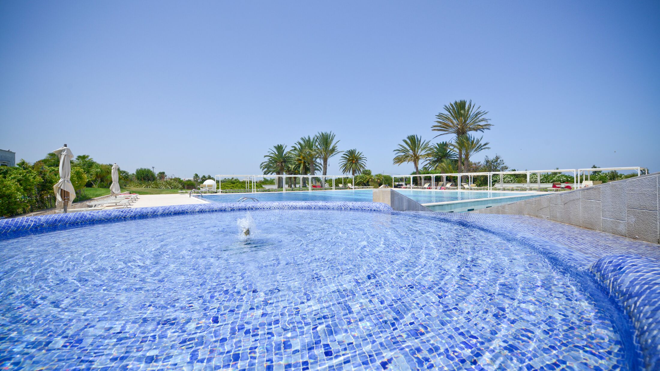 a pool next to a body of water