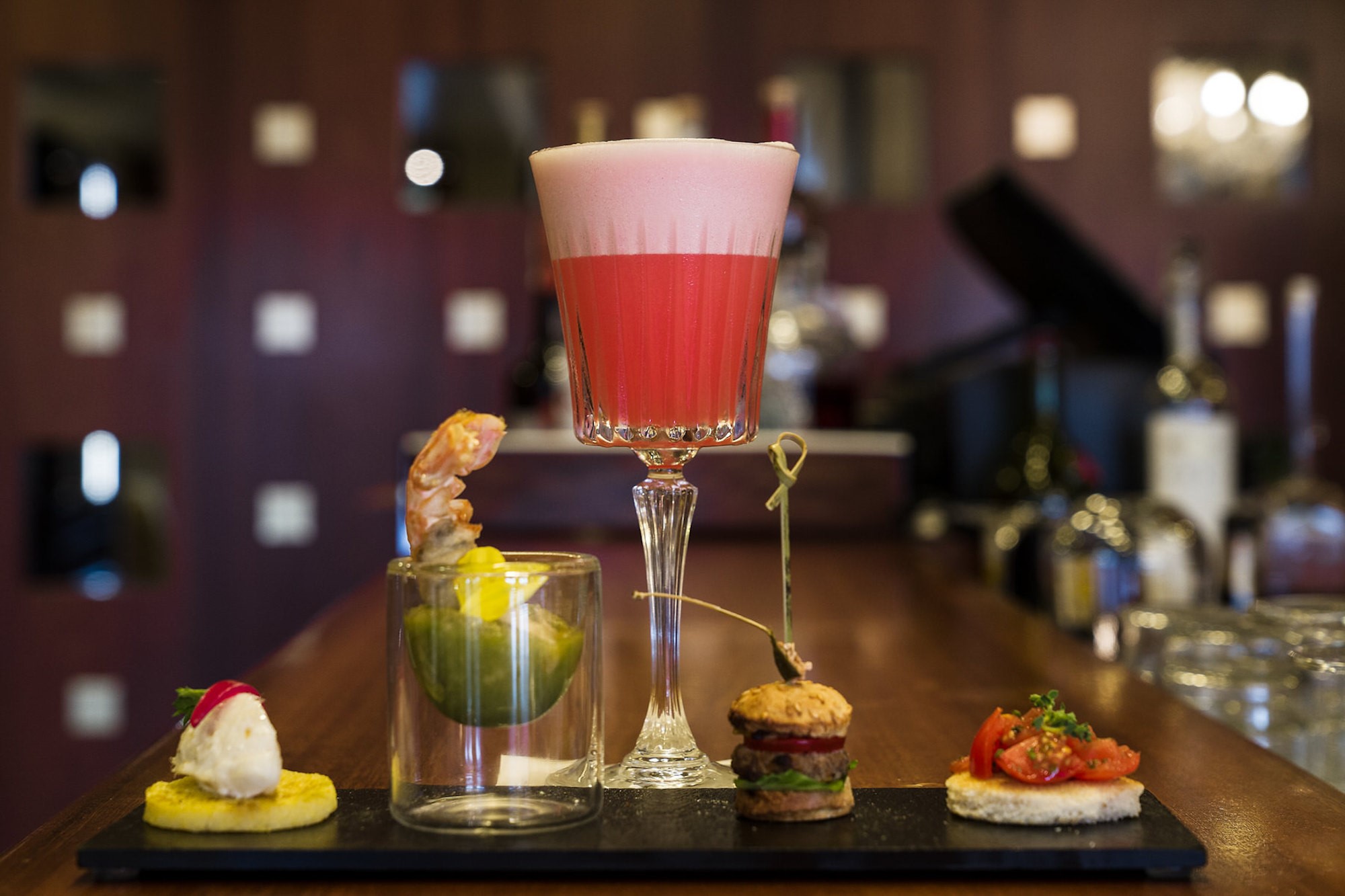 a table topped with plates of food and a glass of wine